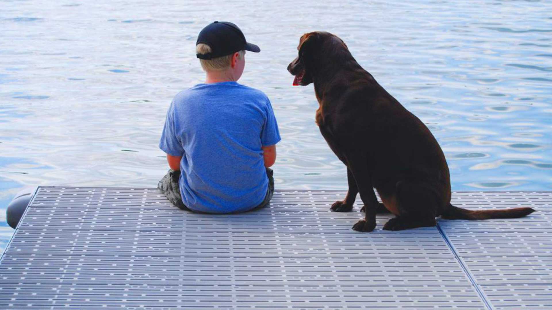 boy on dock with dog